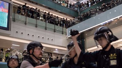 Riot police chased protesters into a shopping mall.