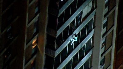 Man scales down building