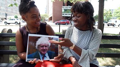 Two Americans looking at a photo of Boris Johnson