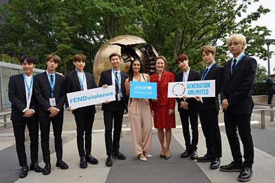 BTS-UNICEF-stand-together-in-front-of-a-sculpture.