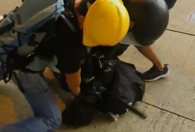 Hong Kong police arrest a protester with the help of a suspected undercover officer