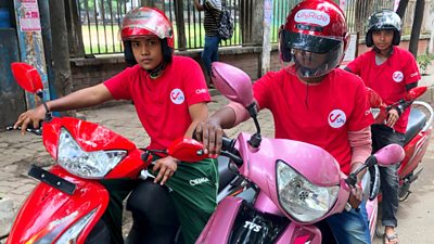 Three women on scooters