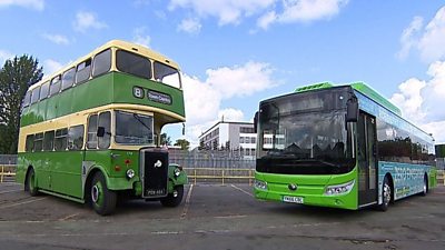 An old fashioned bus next to a new style bus