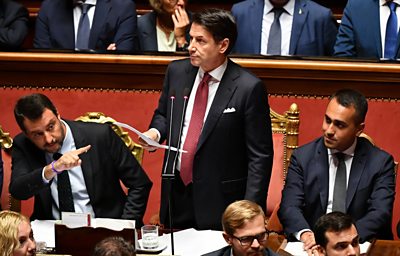 Italy's PM Giuseppe Conte addresses Senate flanked by Matteo Salvini (L) and Luigi Di Maio (R)