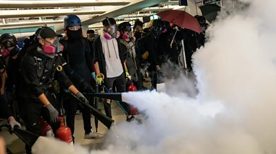 HK protesters letting off fire extinguishers