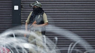 A security personnel stands guard on a street in Srinagar on August 28, 2019