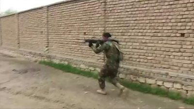 A member of the Afghan security forces fights Taliban militants in Kunduz