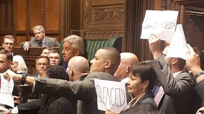 MPs protest around the Speaker's chair