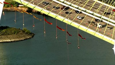 A group of protesters suspended themselves from a bridge in protest over fossil fuels.