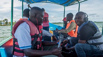 Producers from Bukedde and Star FM in Uganda prepare to interview fishermen during a fishing expedition on Lake Victoria