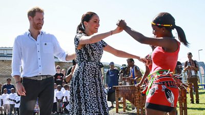 Harry and Meghan dance after arriving in Africa