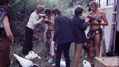 Michael Palin, Terry Jones and Graham Chapman are fitted with outlandish medieval warrior costumes on location