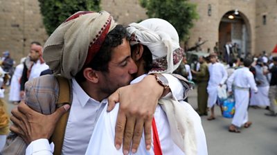 Yemeni detainees hug relatives after being released by the rebel Houthi movement in Sanaa (30 September 2019)