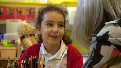 A girl with a teaching assistant