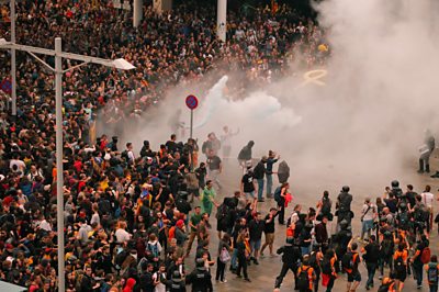 Huge crowds of protesters clash with police officers at Barcelona airport