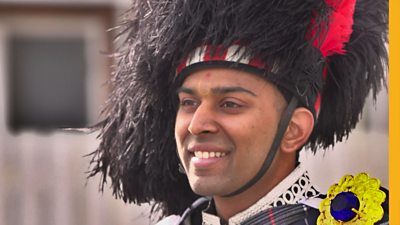 For Darshil, playing the bagpipes is the perfect way to honour the teachings of his Hindu guru. He leads the pipe band through the streets of North-West England.