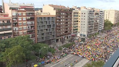 Demonstrators march down a main road in Barcelona on the fifth day of protests