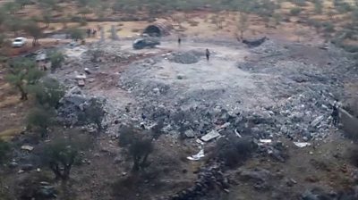 Drone footage shows flattened debris following the US raid that killed the Islamic State leader.