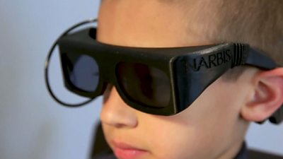 A child wears a pair of smart glasses