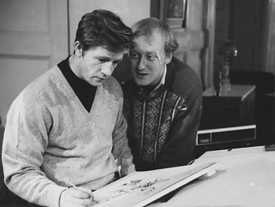 Two men, one of them sketching