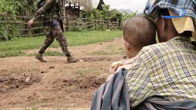 An ethnic armed group soldier walks through a village in Kayah state, Myanmar