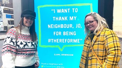 Jo Stretch and Claire Johnson next to the billboard