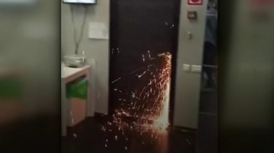Sparks fly as a door is cut open