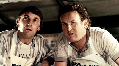 Donal O'Kelly and Colm Meaney in aprons in the back of their van