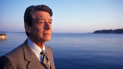 John Hurt in stands by a bay in early evening