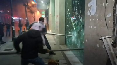 Protesters smash window