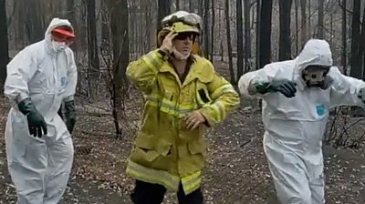 Three firefighters dance in a TikTok video