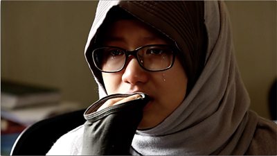 Nada Fedulla cries as she asks for help to return home to Indonesia.