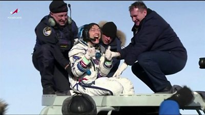 Christina Koch is lifted from the capsule
