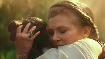 A digitally recreated Carrie Fisher (playing Princess Leia) hugs Daisy Ridley (playing Rey)