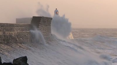 wave crashing against lighthouse