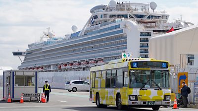 Bus carrying passengers away from the Diamond Princess in Yokohama, Japan.