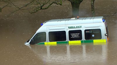 An ambulance submerged in flood water in Wales following Storm Dennis