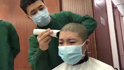 Woman's hair being shaved off