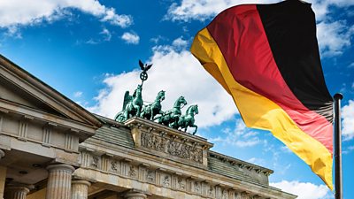 The Brandenburg Gate and a German flag