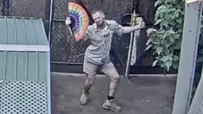 Man dancing with rainbow fan