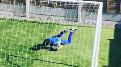 A child diving in goal