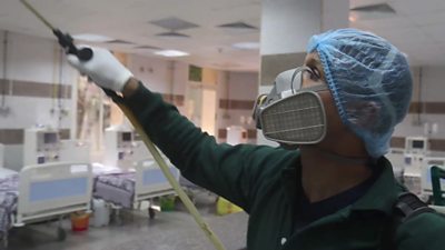 Man spraying disinfectant in hospital