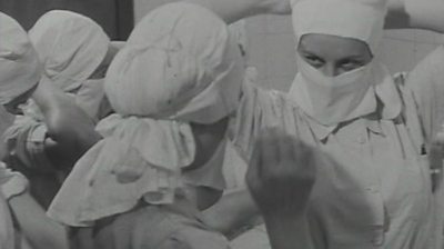 Nurse donning scrubs