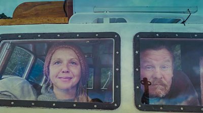 Woman and man looking out van window