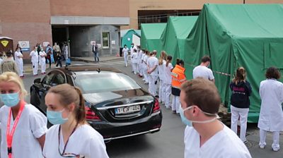 Hospital staff turn their backs