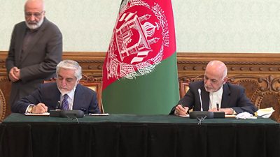Abdullah Abdullah (seated, left) and President Ashraf Ghani (seated, right) sign a power-sharing deal in Kabul
