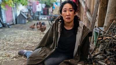 Sandra Oh as the secret agent in Killing Eve slumped on the ground