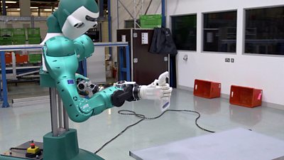 A robot holding a spray bottle