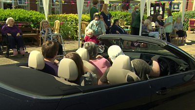 Family in car visiting care home resident