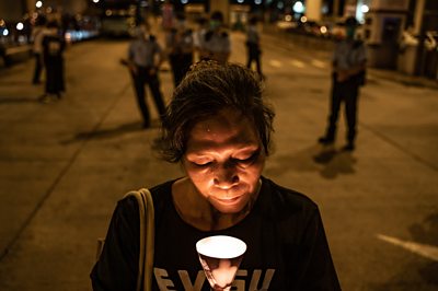 Pro democracy activist holds a candle